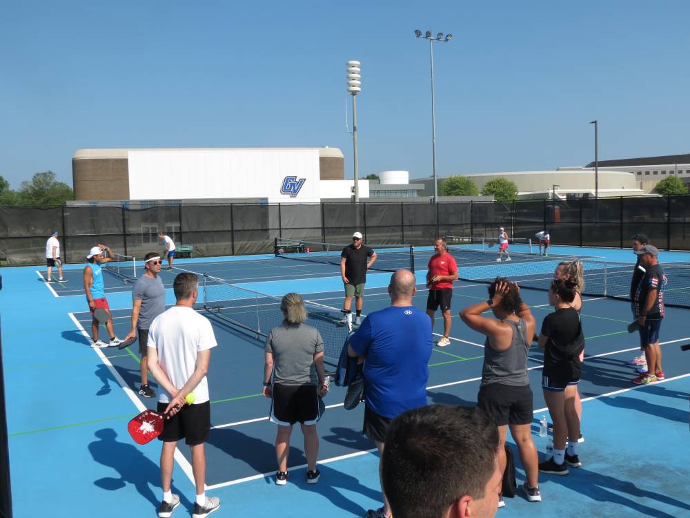 Everyone standing in a group before starting Pickleball.